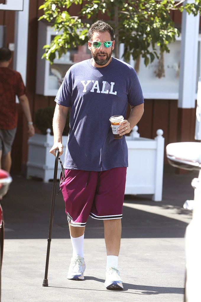 Adam Sandler uses a cane after hip surgery