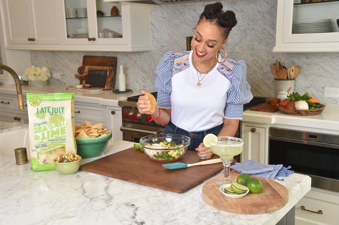 Tia Mowry Making Cocktails and Dip With a bag of Late July Organic Restaurant Tortilla Chips