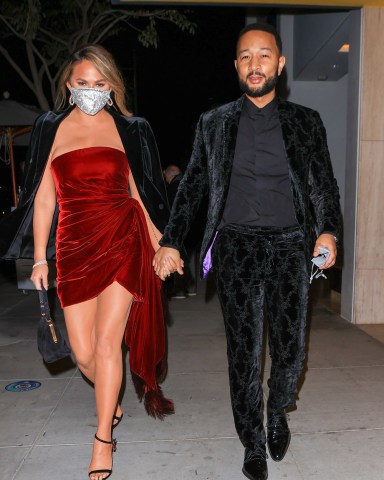 Grammy Winner John Legend and wife Chrissy Teigen stun as they celebrate his Grammy win. 14 Mar 2021 Pictured: Grammy Winner John Legend and wife Chrissy Teigen stun as they celebrate his win. Photo credit: Rachpoot/MEGA TheMegaAgency.com +1 888 505 6342 (Mega Agency TagID: MEGA739599_001.jpg) [Photo via Mega Agency]