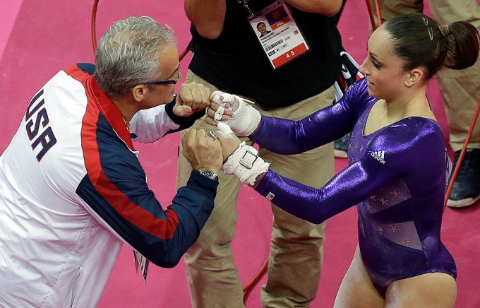 Jordyn Wieber gets a pep talk from coach John Geddert