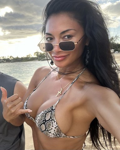 Hawaii, HI  - *EXCLUSIVE*  - Singer Nicole Scherzinger is seen having a little fun in the sun on the beach with her cousins during her sun-soaked holiday in Hawaii.

The 44-year-old Pussycat Doll showed off her sultry physique wearing her sexy animal-printed bikini out on Makaha Beach with the family.

The sexy star recently revealed some happy news on social media as she announced that she is engaged to her beau Thom Evans after three years of dating.  **SHOT ON 06/26/2023**

Pictured: Nicole Scherzinger

BACKGRID USA 28 JUNE 2023 

USA: +1 310 798 9111 / usasales@backgrid.com

UK: +44 208 344 2007 / uksales@backgrid.com

*UK Clients - Pictures Containing Children
Please Pixelate Face Prior To Publication*