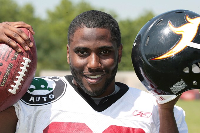 John David Washington poses with a football