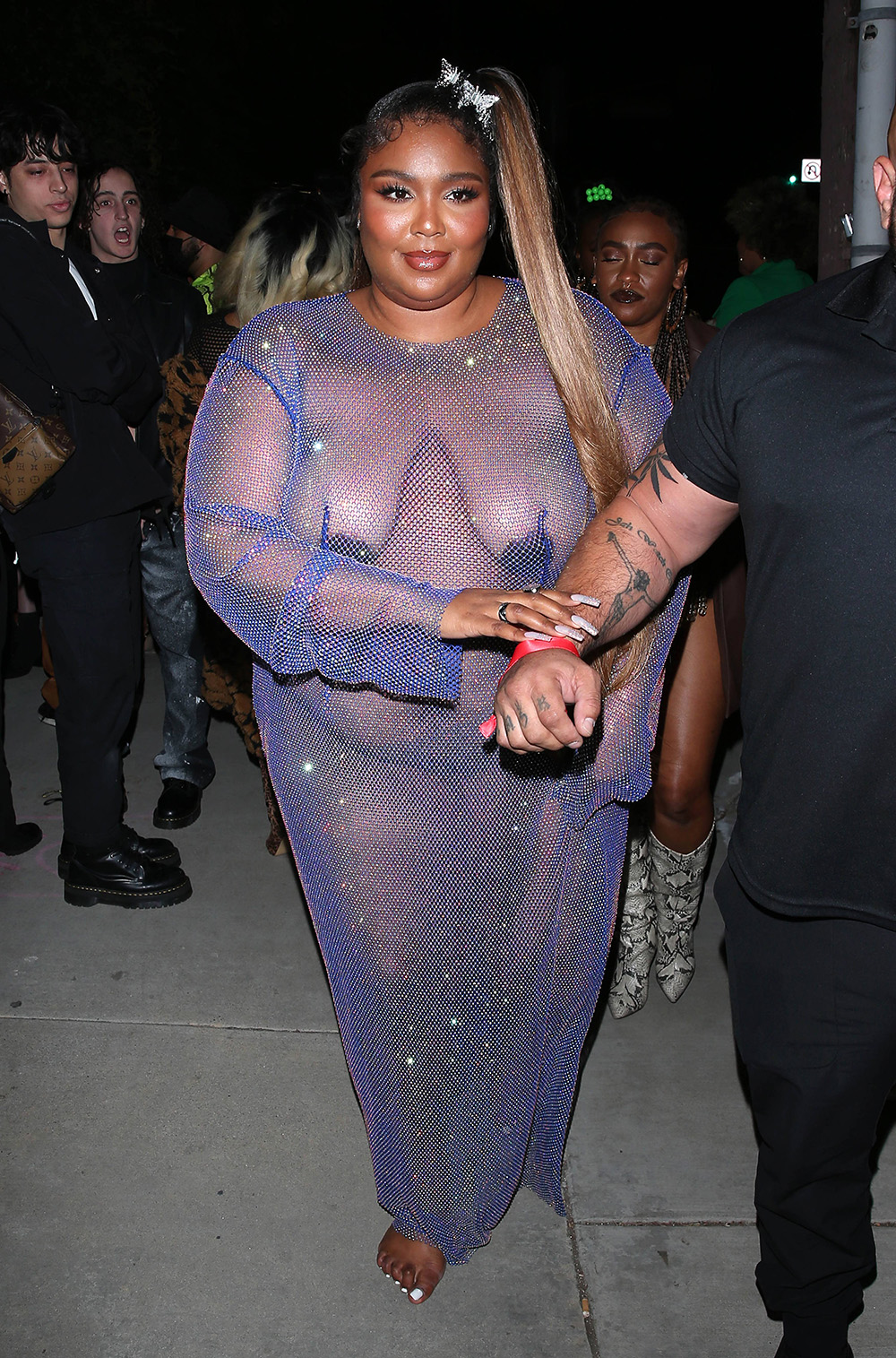 Lizzo leaves little to the imagination in a 'barely there' outfit while leaving Cardi B's Birthday party