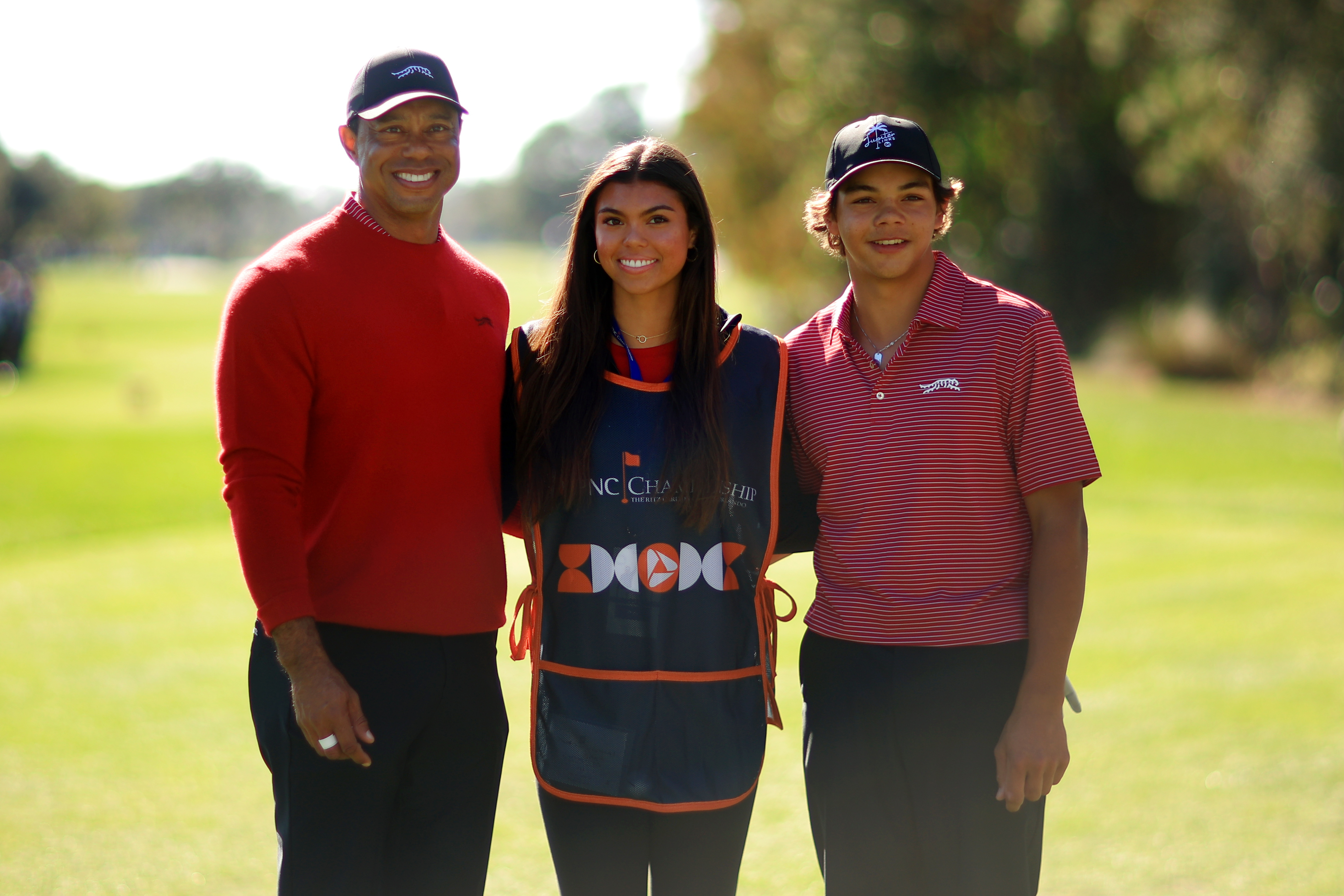 ORLANDO, FLORIDA - DECEMBER 22: Tiger Woods of the United States with his son Charlie Woods and daughter Sam Woods stand on the first tee during the second round of the PNC Championship at Ritz-Carlton Golf Club on December 22, 2024 in Orlando, Florida. (Photo by Mike Ehrmann/Getty Images)