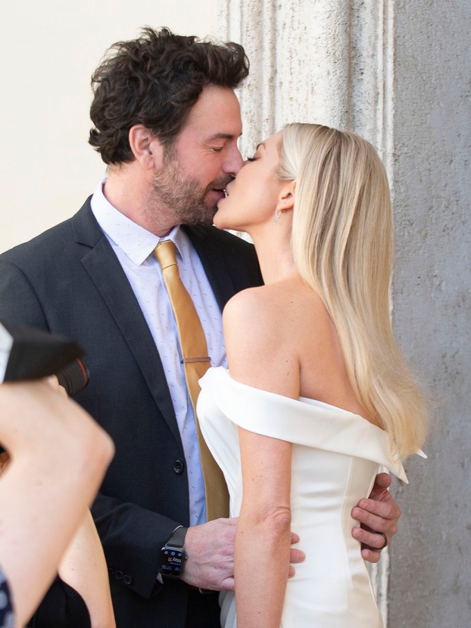 Stassi Schroeder and Beau Clark kiss before their wedding in Italy