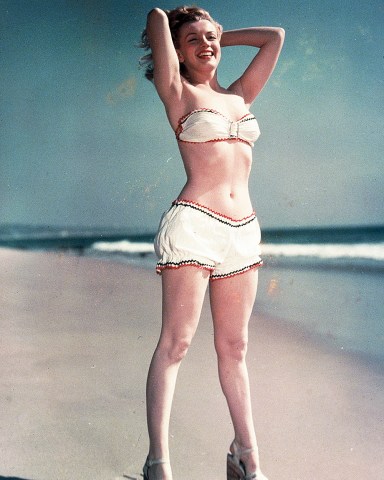 Editorial use only
Mandatory Credit: Photo by Snap/Shutterstock (390853hm)
FILM STILLS OF 1947, BATHING SUIT, BEACH, CLOTHING, MARILYN MONROE, OCEAN, PIN-UPS, BIKINI, TWO PIECE, OUTSIDE, SAND, MIDRIFF, SHOES, FULL LENGTH, ARMS BEHIND HEAD IN 1947
VARIOUS