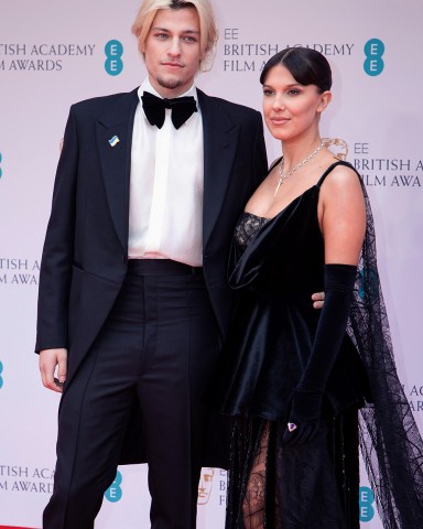 Millie Bobby Brown, left, and Jake Bongiovi pose for photographers upon arrival at the 75th British Academy Film Awards, BAFTA's, in LondonBafta Film Awards 2022 Arrivals, London, United Kingdom - 13 Mar 2022