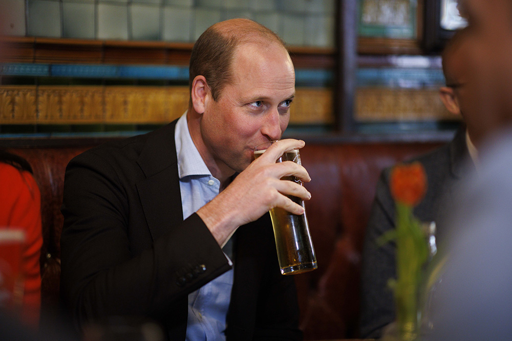 Prince William drinks a pint of cider as he chats to local business people inside the Dog and Duck pub.

William, Prince of Wales and Catherine, Princess of Wales at the Dog and Duck pub in Soho ahead of this weekend's coronation.
Prince William and Catherine Princess of Wales visit to the Dog & Duck Pub, Soho, London, Soho, London, UK - 04 May 2023