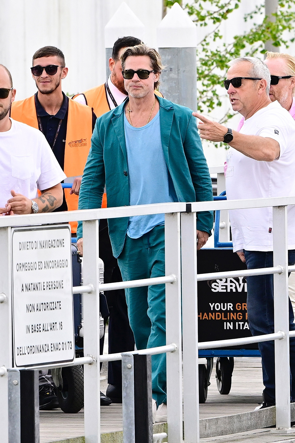 Brad Pitt exits the Venice Airport with friends during his time at the 79th Venice Film Festival