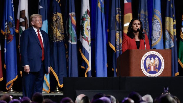 (L-R) Former US President and 2024 Republican presidential candidate Donald Trump looks on as former US Representative Tulsi Gabbard endorses him while she speaks at the National Guard Association conference in Detroit, Michigan, on August 26, 2024. (Photo by JEFF KOWALSKY / AFP) (Photo by JEFF KOWALSKY/AFP via Getty Images)