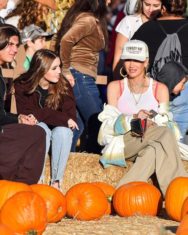 EXCLUSIVE: Gwen Stefani Took Her Boys Kingston, Zuma, & Apollo To The Pumpkin Patch At Underwood Farm In Moorpark, CA. The No Doubt Singer Stood Out In Her Fashionable Trademark OC Style As She Enjoyed The Harvest Festivities With Her Boys and Her Extended Family Including Her Parents, Her Two Brothers, And Their Kids. The Family Was Seen Enjoying Some Ice Cream And Tractor Trailer Rides. The 'I'm Just A Girl' Singer Was Also Seen Enjoying Herself As She Took Selfies And Wore Khaki Pants Along With Her Trademark Tank Top Under An Oversized Plaid Shirt and A Hat That Said 'Cowboy Hat'. Her Oldest Son Kingston Looked To Be Getting Older And Taller And Also Brought Along His Girlfriend. 23 Oct 2022 Pictured: Gwen Stefani Took Her Boys Kingston, Zuma, & Apollo To The Pumpkin Patch At Underwood Farm In Moorpark, CA. The No Doubt Singer Stood Out In Her Fashionable Trademark OC Style As She Enjoyed The Harvest Festivities With Her Boys and Her Extended Family Including Her Parents, Her Two Brothers, And Their Kids. The Family Was Seen Enjoying Some Ice Cream And Tractor Trailer Rides. The 'I'm Just A Girl' Singer Was Also Seen Enjoying Herself As She Took Selfies And Wore Khaki Pants Along With Her Trademark Tank Top Under An Oversized Plaid Shirt and A Hat That Said 'Cowboy Hat'. Her Oldest Son Kingston Looked To Be Getting Older And Taller And Also Brought Along His Girlfriend. Photo credit: @CelebCandidly / MEGA TheMegaAgency.com +1 888 505 6342 (Mega Agency TagID: MEGA910784_023.jpg) [Photo via Mega Agency]