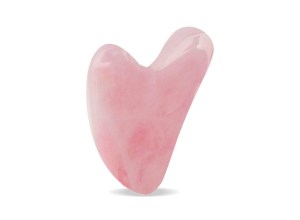 A rose quartz gua sha tool