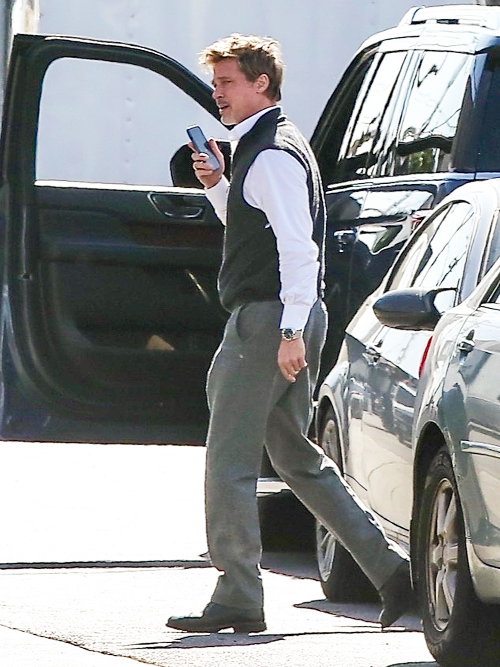 *EXCLUSIVE* Brad Pitt takes a call as he arrives on the set of 'Wolves' in LA