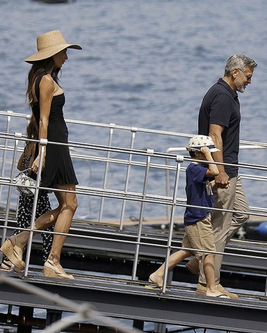 Como, ITALY  - George and Amal Clooney, along with their sleepy kids Ella and Alexander, embark on a boat trip in Como. Waving at passersby, George sports a classy look with sunglasses, a blue shirt, and khaki pants, while Amal turns heads in a sun hat and black dress

Pictured: George Clooney, Amal Clooney

BACKGRID USA 28 JULY 2023 

USA: +1 310 798 9111 / usasales@backgrid.com

UK: +44 208 344 2007 / uksales@backgrid.com

*UK Clients - Pictures Containing Children
Please Pixelate Face Prior To Publication*