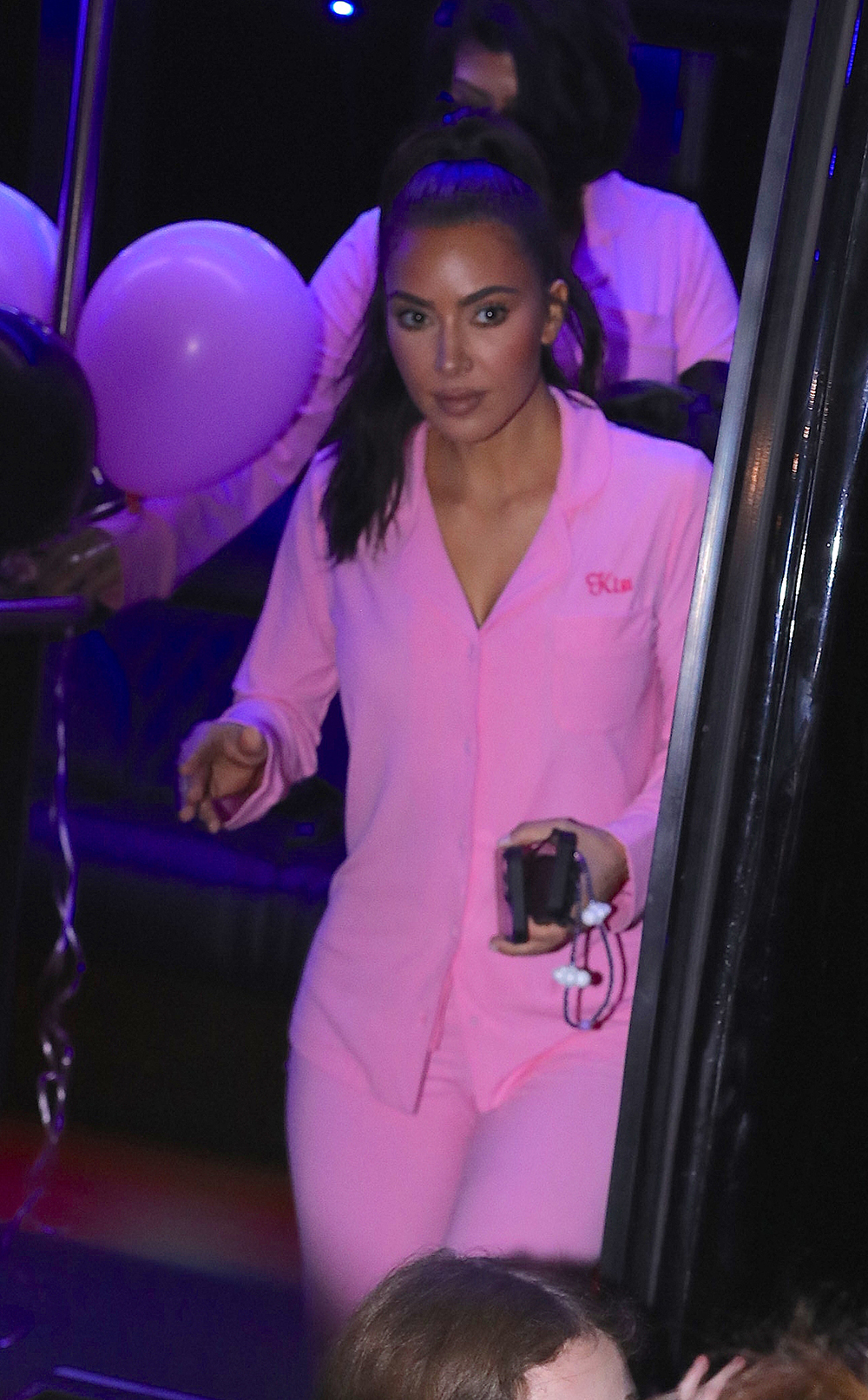 Kim Kardashian wears custom pink sleepwear outfit as she matches her daughter North and sister Kourtney as they celebrate on a party bus for her 10th birthday in LA