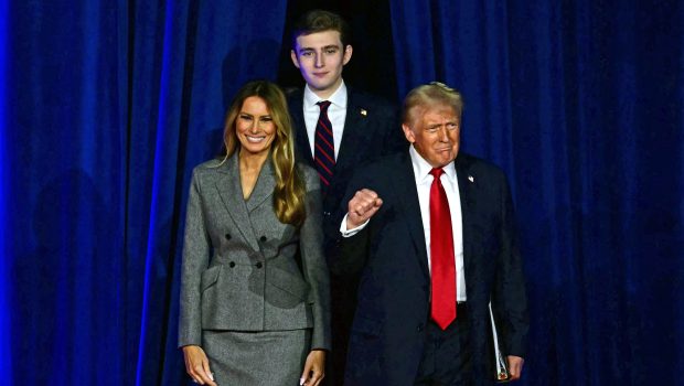 TOPSHOT - Former US President and Republican presidential candidate Donald Trump (R) arrives for an election night event alongside former US First Lady Melania Trump and his son Barron Trump at the West Palm Beach Convention Center in West Palm Beach, Florida, on November 6, 2024. (Photo by Jim WATSON / AFP) (Photo by JIM WATSON/AFP via Getty Images)