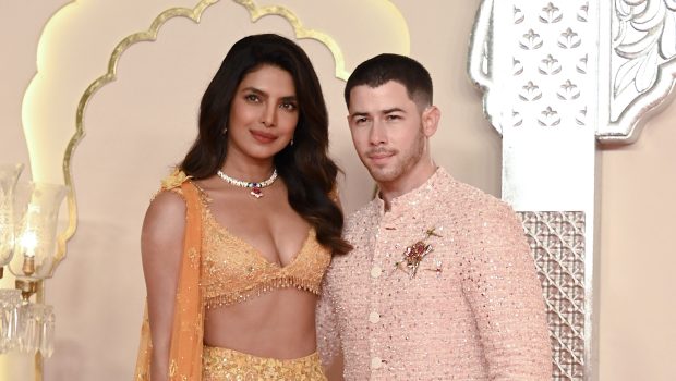 Indian actress Priyanka Chopra Jonas (L) and her husband American singer-songwriter and actor Nick Jonas (R) pose for photos as they arrive to attend the wedding ceremony of billionaire tycoon and Chairman of Reliance Industries Mukesh Ambani's son Anant Ambani and Radhika Merchant in Mumbai on July 12, 2024. Socialite sisters Kim and Khloe Kardashian were among the global celebrities spotted in India on July 12 to attend a lavish three-day wedding ceremony staged by Asia's richest man Mukesh Ambani. (Photo by SUJIT JAISWAL / AFP) (Photo by SUJIT JAISWAL/AFP via Getty Images)