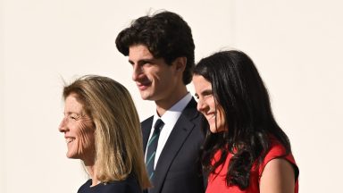 BOSTON, MASSACHUSETTS - DECEMBER 02: Ambassador Caroline Kennedy, Tatiana Schlossberg and Jack Schlossberg wait to greet Prince William, Prince of Wales during his visit to John F. Kennedy Presidential Library and Museum on December 02, 2022 in Boston, Massachusetts. The Prince and Princess of Wales are visiting the coastal city of Boston to attend the second annual Earthshot Prize Awards Ceremony, an event which celebrates those whose work is helping to repair the planet. During their trip, which will last for three days, the royal couple will learn about the environmental challenges Boston faces as well as meeting those who are combating the effects of climate change in the area. (Photo by Karwai Tang/WireImage)