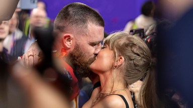 Travis Kelce and Taylor Swift kissing at Super Bowl LVIII