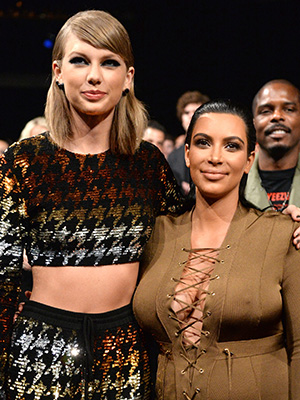 Taylor Swift and Kim Kardashian posing for pictures at the 2025 VMAs