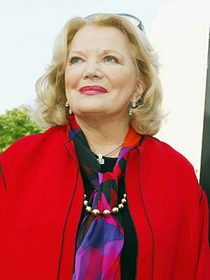 Gena Rowlands in front of a Notebook billboard
