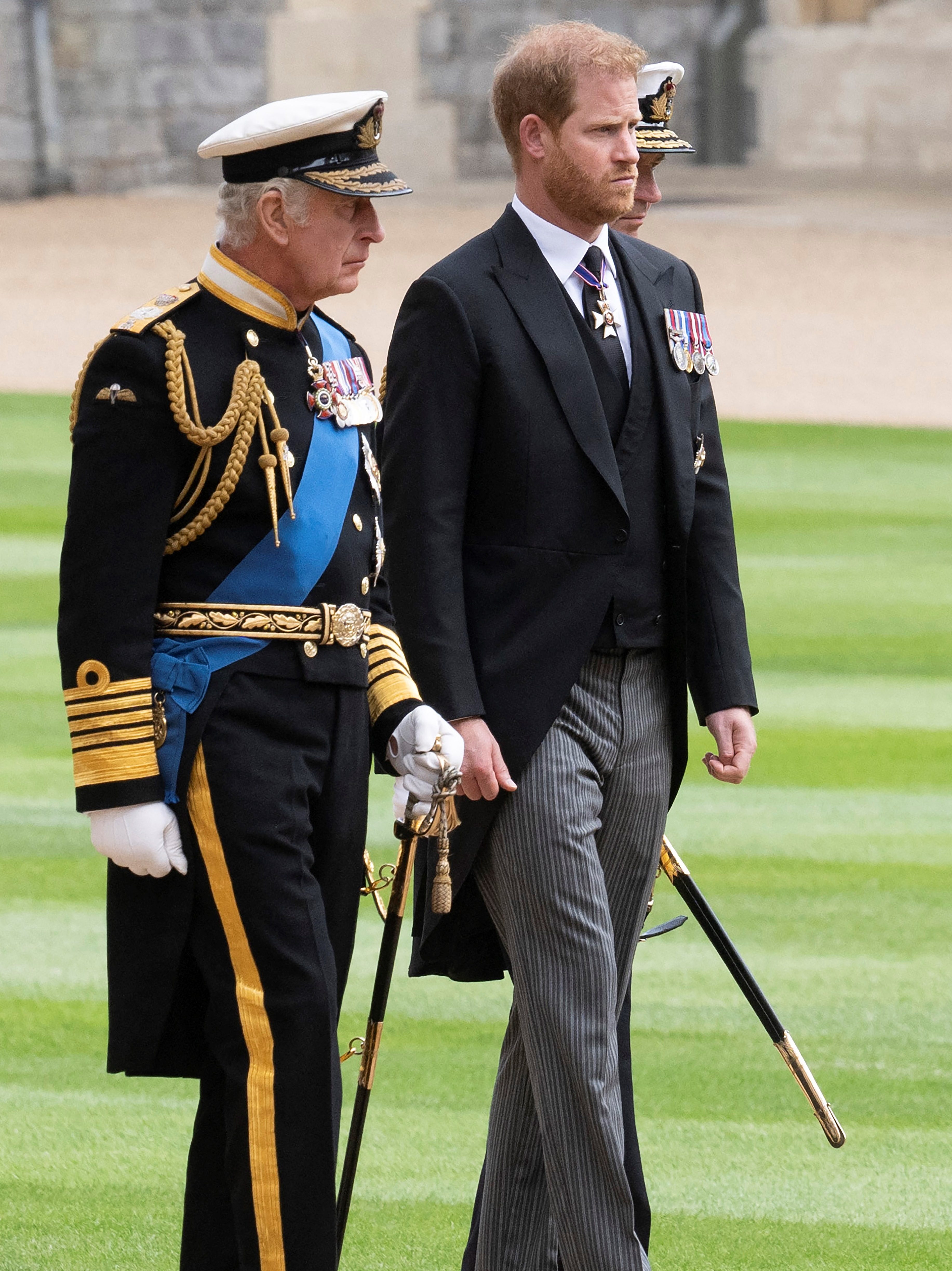 Britain's King Charles III (L) walks with his son Britain's Prince Harry, Duke of Sussex as they arrive at St George's Chapel inside Windsor Castle on September 19, 2022, ahead of the Committal Service for Britain's Queen Elizabeth II. Monday's committal service is expected to be attended by at least 800 people, most of whom will not have been at the earlier State Funeral at Westminster Abbey. (Photo by David Rose / POOL / AFP) (Photo by DAVID ROSE/POOL/AFP via Getty Images)