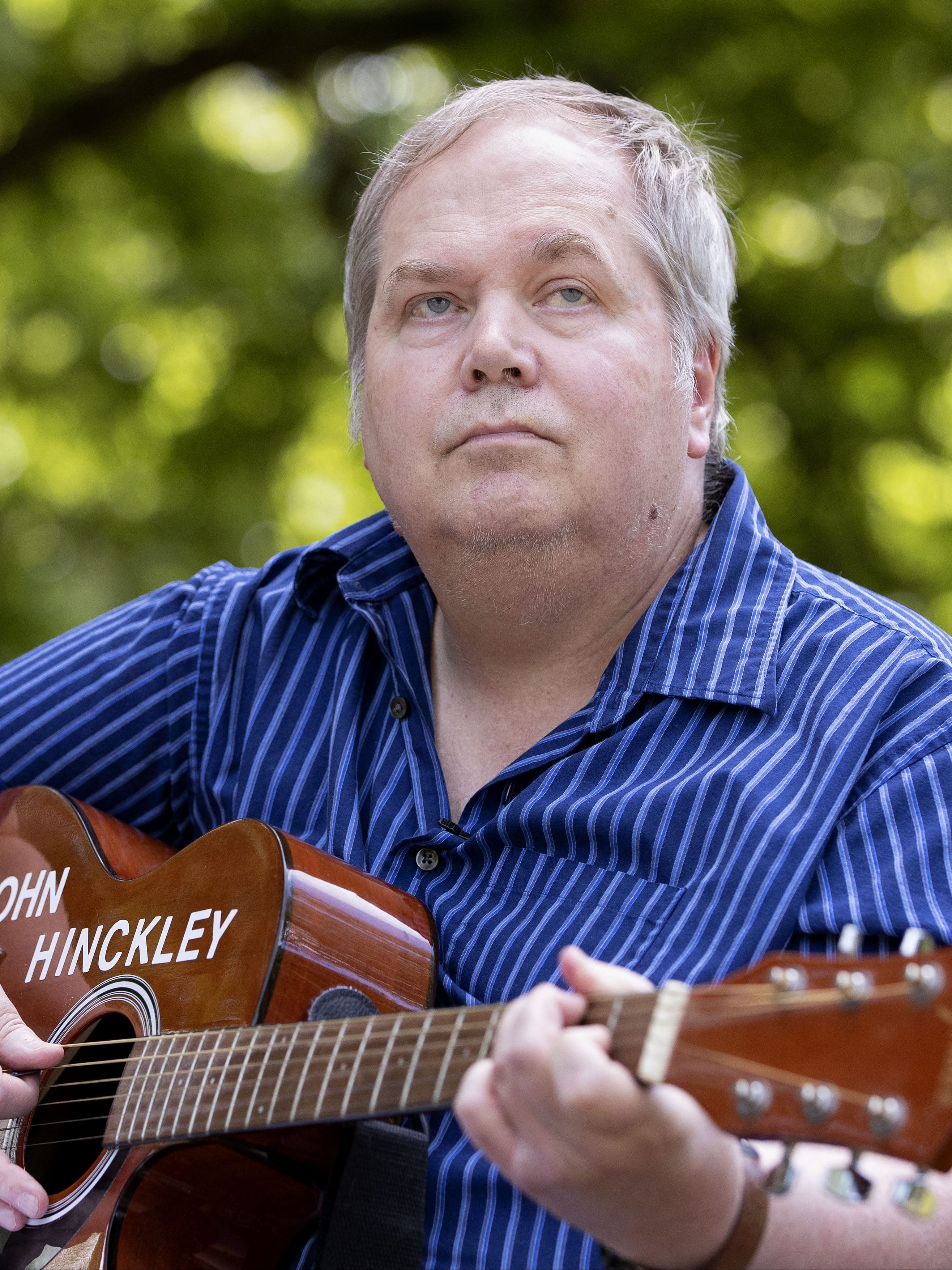 John Hinckley Jr. plays his guitar in Williamsburg, Virginia, on September 14, 2022. - More than four decades after John Hinckley shot Ronald Reagan, the man who was acquitted of the crime on an insanity defense and subsequently hospitalized for 34 years is fully free.
But the one thing he wants most after decades of treatments and years of conditional release still eludes him: a guitarist and songwriter, Hinckley longs to play a live concert. (Photo by Ryan M. Kelly / AFP) (Photo by RYAN M. KELLY/AFP via Getty Images)