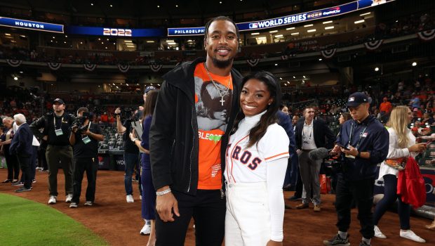 HOUSTON, TX - OCTOBER 28:  Olympic gold medalist Simone Biles and Houston Texans safety Jonathan Owens are seen prior to Game 1 of the 2022 World Series between the Philadelphia Phillies and the Houston Astros at Minute Maid Park on Friday, October 28, 2022 in Houston, Texas. (Photo by Mary DeCicco/MLB Photos via Getty Images)