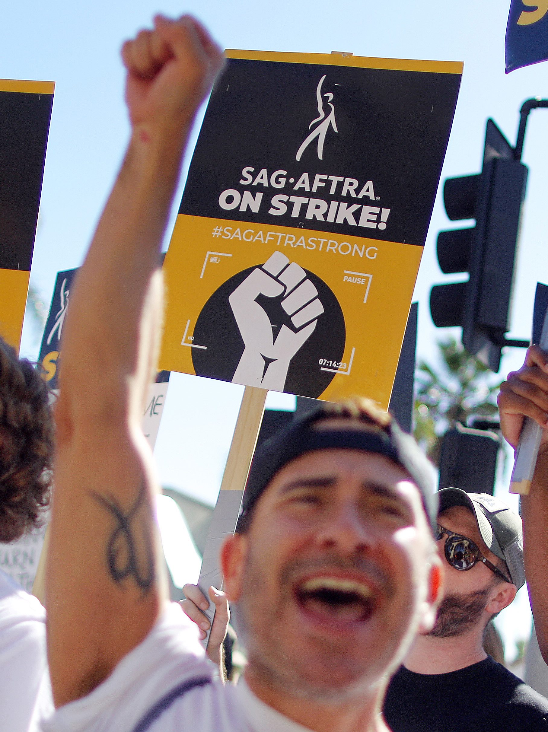 LOS ANGELES, CALIFORNIA - NOVEMBER 08: SAG-AFTRA members and supporters chant outside Paramount Studios on day 118 of their strike against the Hollywood studios on November 8, 2023 in Los Angeles, California. A tentative labor agreement has been reached between the actors union and the Alliance of Motion Picture and Television Producers (AMPTP) with the strike set to end after midnight. (Photo by Mario Tama/Getty Images)