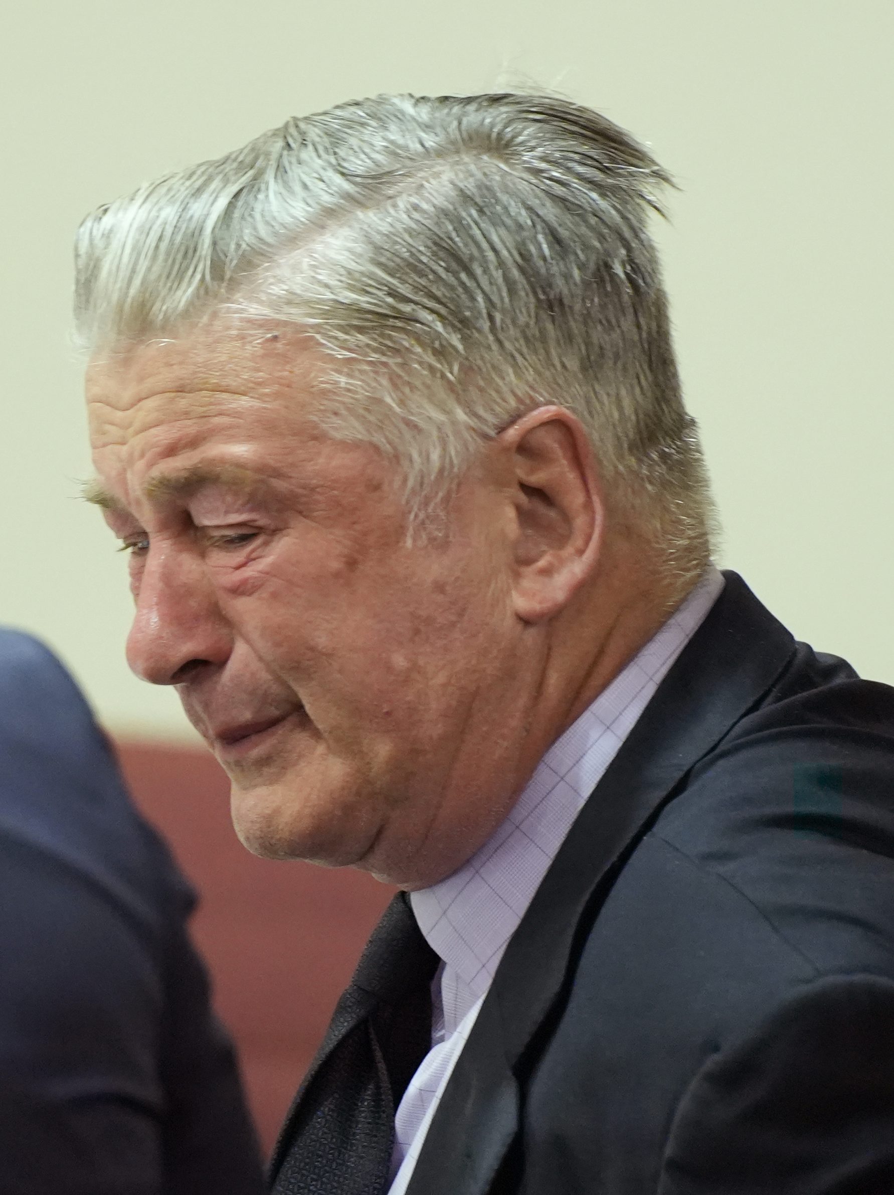 SANTA FE, NEW MEXICO - JULY 12: Alec Baldwin reacts as he sits between his attorneys Alex Spiro (L) and Luke Nikas (R) at the conclusion of his trial for involuntary manslaughter in First Judicial District Court on July 12, 2024 in Santa Fe, New Mexico. The trial for involuntary manslaughter was dismissed by a judge Friday after she ruled that key evidence over a fatal shooting on the set of "Rust" had been withheld from the defense. (Photo by Ramsay de Give-Pool/Getty Images)