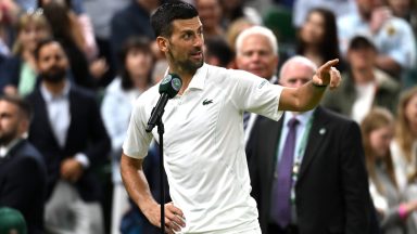 LONDON, ENGLAND - JULY 08: Novak Djokovic of Serbia addresses the crowd on Centre Court wishing them a 'good night' following victory against Holger Rune of Denmark in his Gentlemen's Singles fourth round match during day eight of The Championships Wimbledon 2024 at All England Lawn Tennis and Croquet Club on July 08, 2024 in London, England. (Photo by Mike Hewitt/Getty Images)