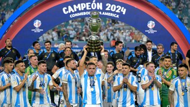 Argentina's forward #22 Lautaro Martinez lifts up the trophy as he celebrates winning the Conmebol 2024 Copa America tournament final football match between Argentina and Colombia at the Hard Rock Stadium, in Miami, Florida on July 14, 2024. (Photo by JUAN MABROMATA / AFP) (Photo by JUAN MABROMATA/AFP via Getty Images)