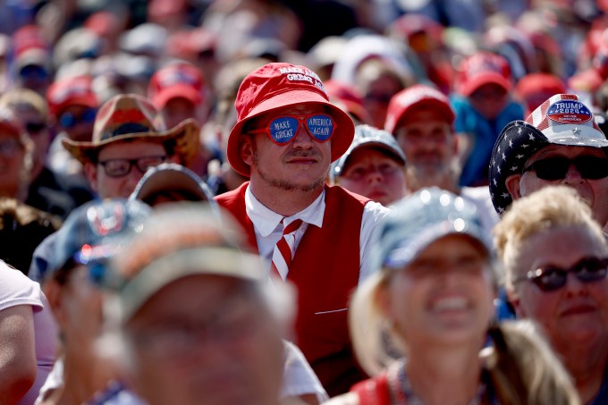 People wait for the start of Donald Trump campaign rally