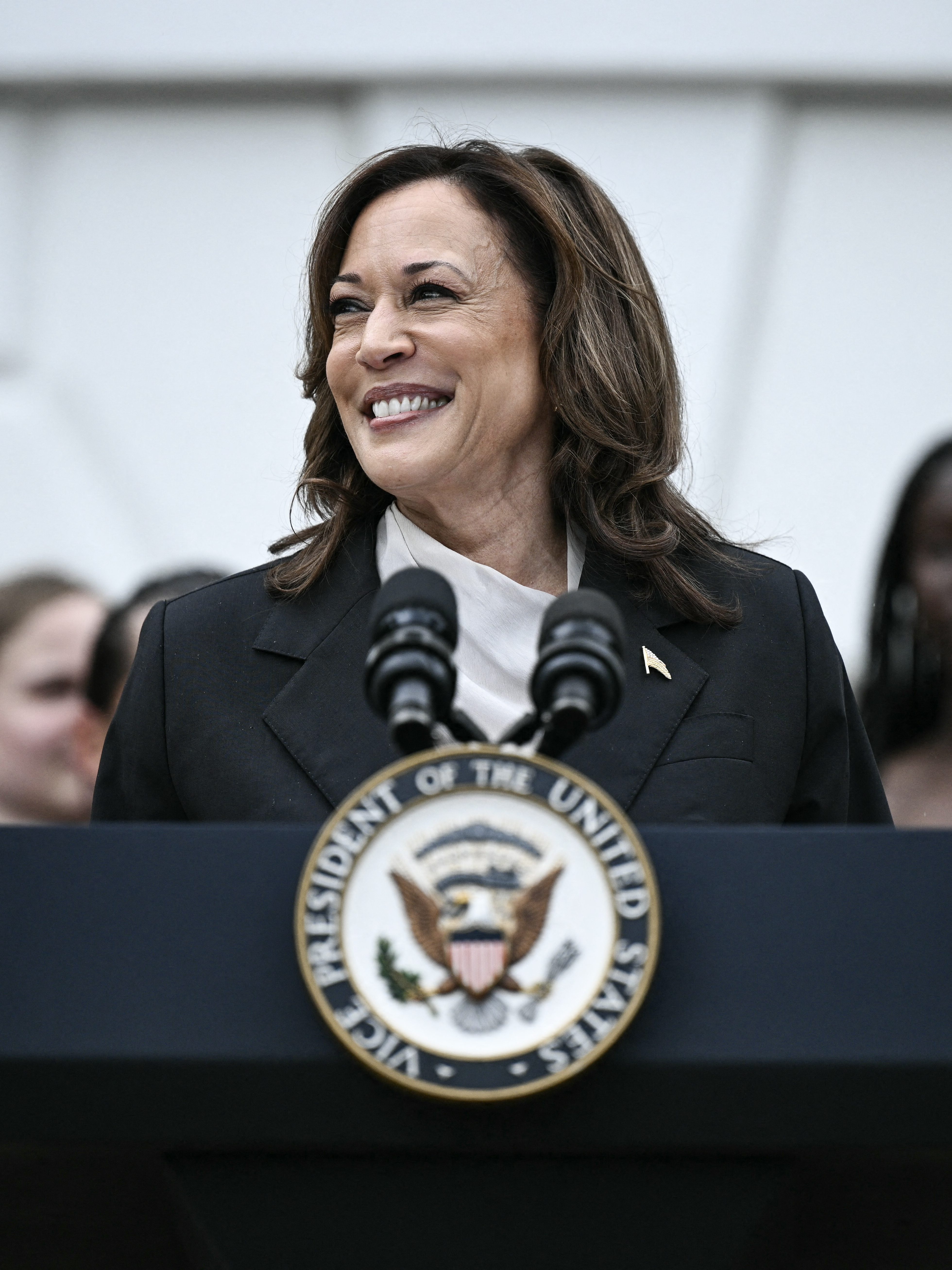 US Vice President Kamala Harris speaks during an event honoring National Collegiate Athletic Association (NCAA) championship teams from the 2023-2024 season, on the South Lawn of the White House in Washington, DC on July 22, 2024. Joe Biden on July 21, 2024 dropped out of the US presidential election and endorsed Vice President Kamala Harris as the Democratic Party's new nominee, in a stunning move that upends an already extraordinary 2024 race for the White House. Biden, 81, said he was acting in the "best interest of my party and the country" by bowing to weeks of pressure after a disastrous June debate against Donald Trump stoked worries about his age and mental fitness. (Photo by Brendan SMIALOWSKI / AFP) (Photo by BRENDAN SMIALOWSKI/AFP via Getty Images)