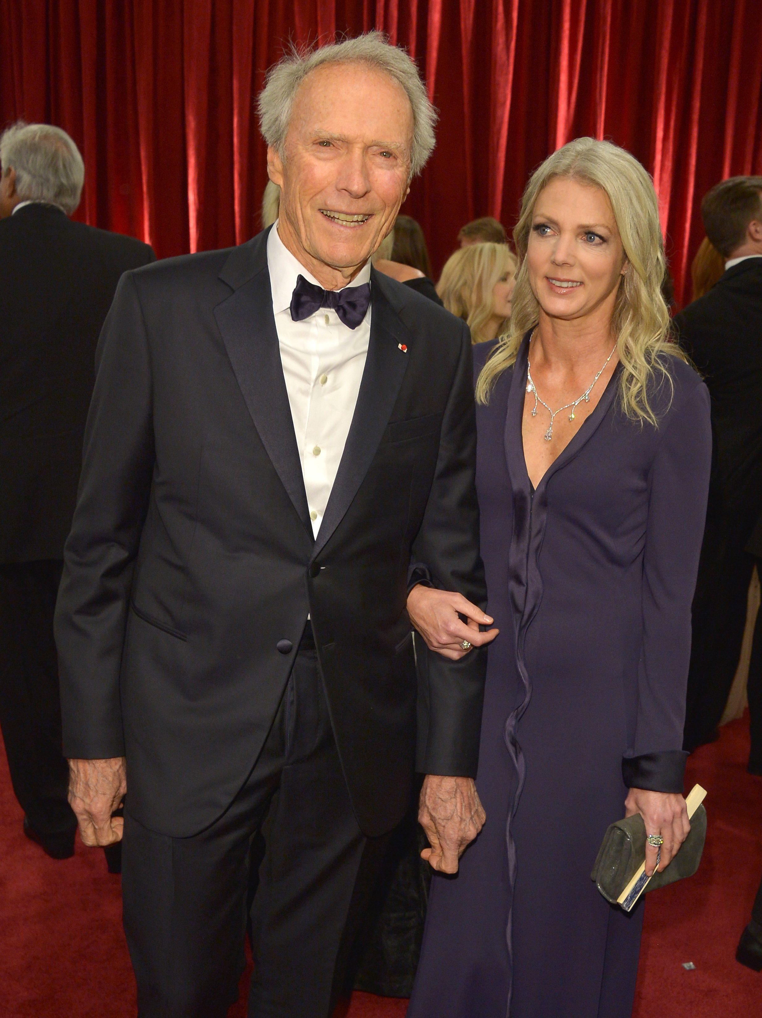 HOLLYWOOD, CA - FEBRUARY 22: Director Clint Eastwood (L) and Christina Sandera attend the 87th Annual Academy Awards at Hollywood & Highland Center on February 22, 2015 in Hollywood, California.  (Photo by George Pimentel/Getty Images)