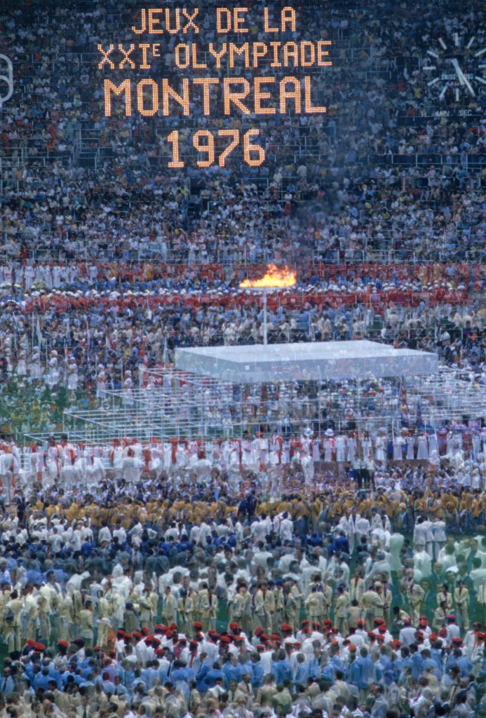 Opening Ceremony: 1976 Summer Olympics: Double exposure and overall view of Stephane Olympic cauldron with flame during Parade of Nations at Olympic Stadium. Montreal, Canada 7/17/1976 CREDIT: Heinz Kluetmeier (Photo by Heinz Kluetmeier /Sports Illustrated via Getty Images) (Set Number: X20682 TK2 R1 )