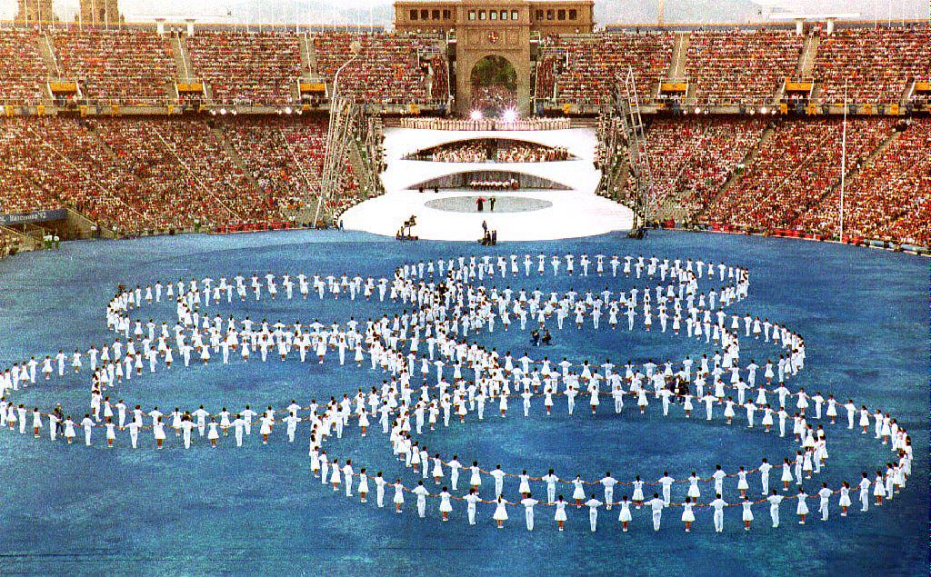 BARCELONA, SPAIN: The Olympic rings are set on the pitch during the opening ceremony of the XXVth Summer Olympics 25 July 1992 at Montjuic Stadium. Approximately 12,000 athletes, officials and coaches from 170 countries are participating in the games. (Photo credit should read MICHEL GANGNE/AFP via Getty Images)