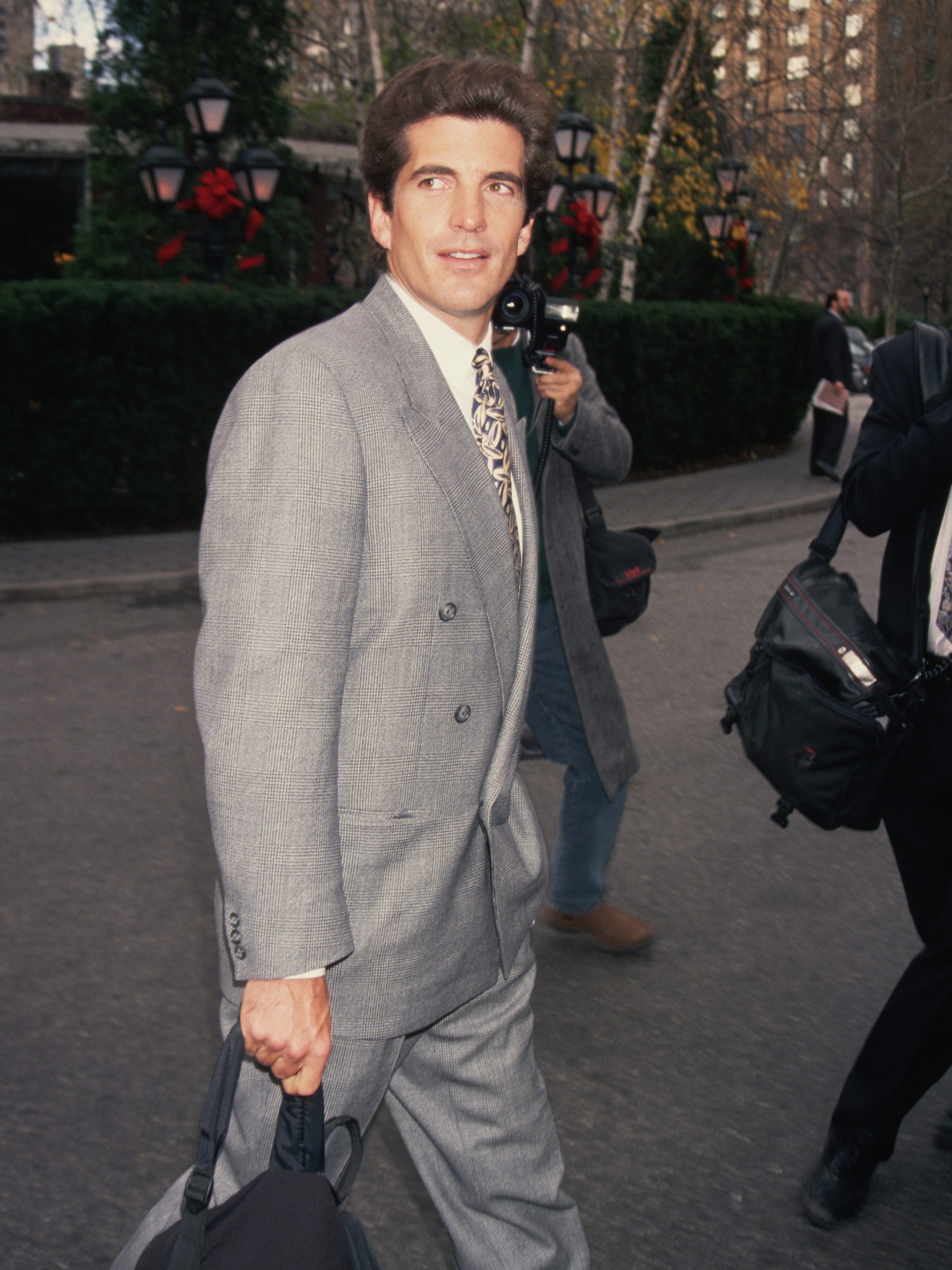 Paparazzi photographers take pictures of John F. Kennedy, Jr. on a New York City street.   (Photo by Mitchell Gerber/Corbis/VCG via Getty Images)