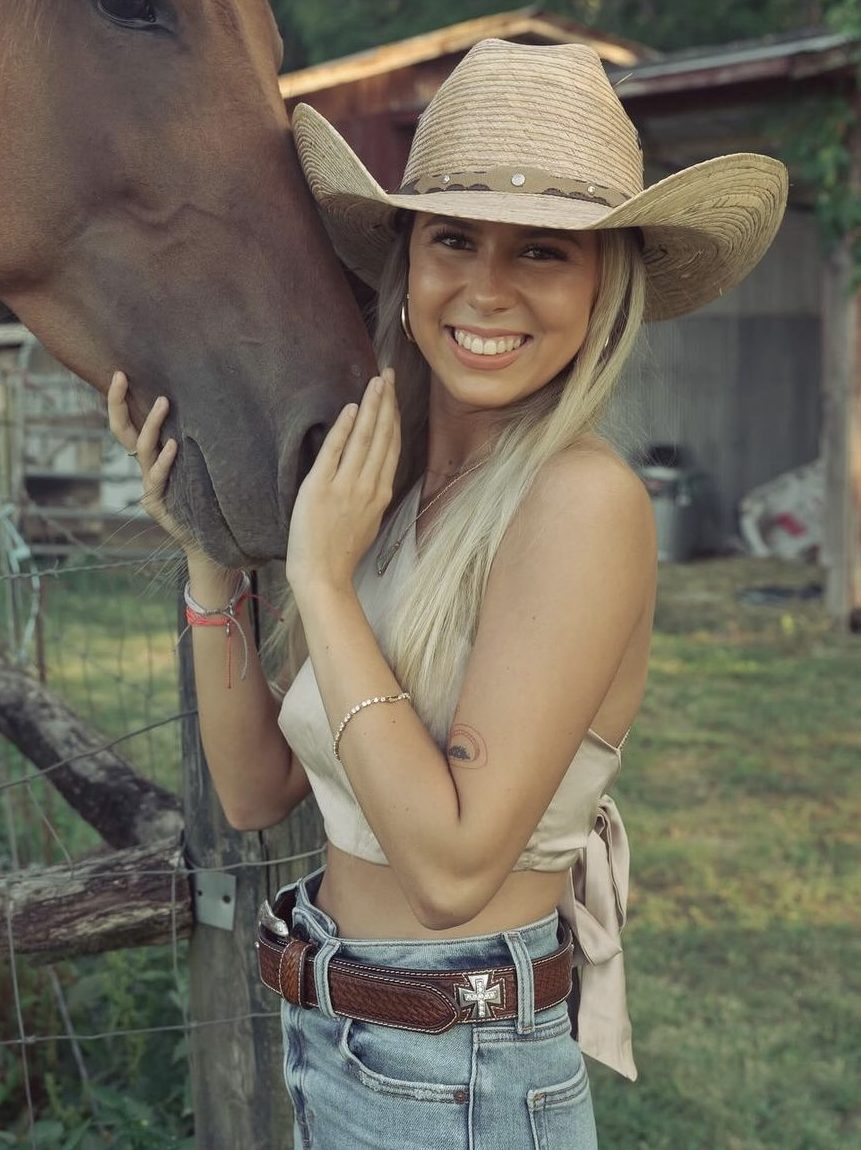 Haliey Welch posing with horse.