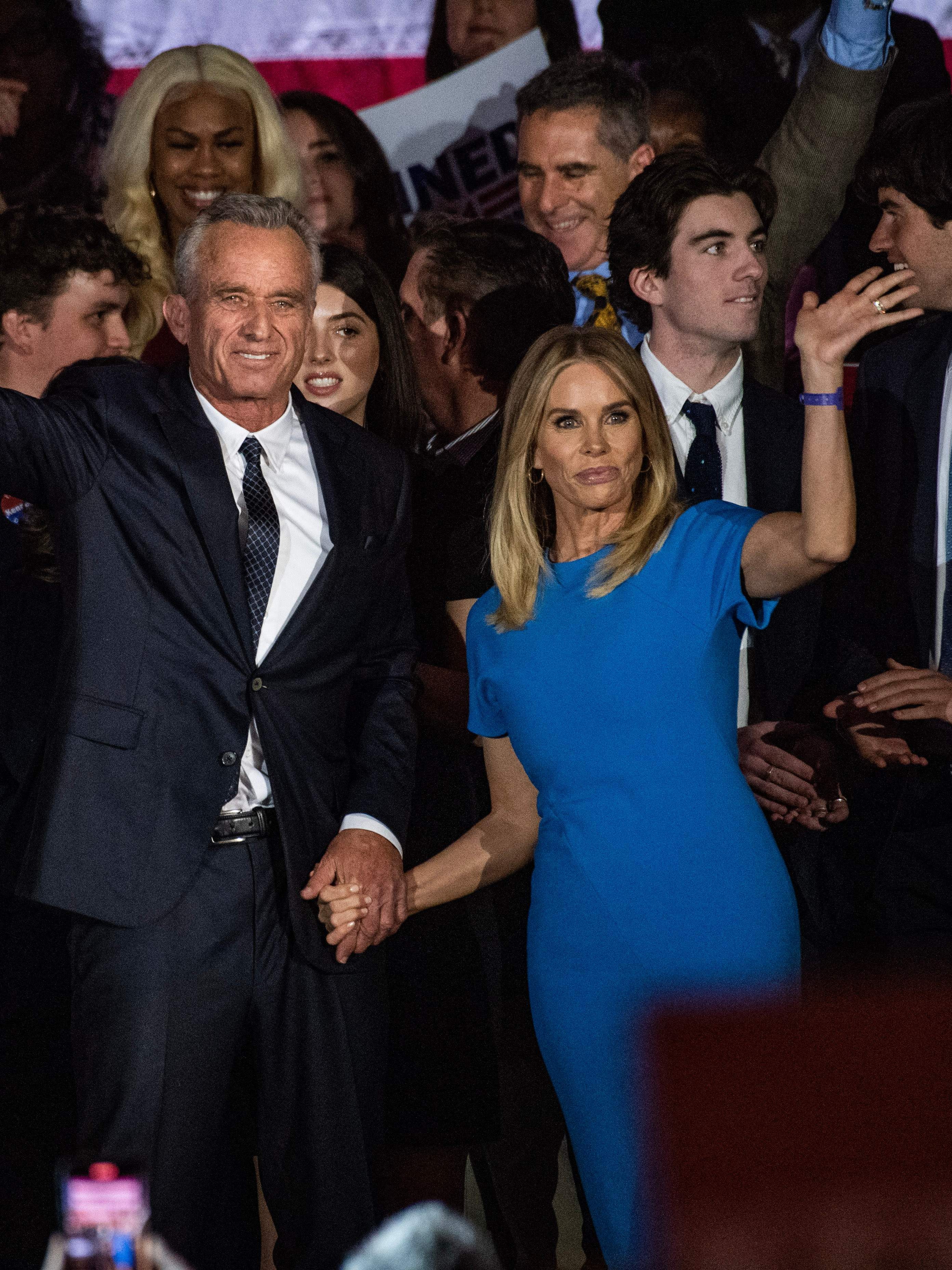 Robert F Kennedy Jr., with his wife Cheryl Hines, waves to supporters during a campaign event to launch his 2024 presidential bid, at the Boston Park Plaza in Boston, Massachusetts, on April 19, 2023. (Photo by JOSEPH PREZIOSO / AFP) (Photo by JOSEPH PREZIOSO/AFP via Getty Images)