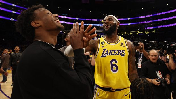 LOS ANGELES, CALIFORNIA - FEBRUARY 07: LeBron James #6 of the Los Angeles Lakers reacts with Bronny James after scoring to pass Kareem Abdul-Jabbar to become the NBA's all-time leading scorer, surpassing Abdul-Jabbar's career total of 38,387 points against the Oklahoma City Thunder at Crypto.com Arena on February 07, 2023 in Los Angeles, California. NOTE TO USER: User expressly acknowledges and agrees that, by downloading and or using this photograph, User is consenting to the terms and conditions of the Getty Images License Agreement. (Photo by Harry How/Getty Images)