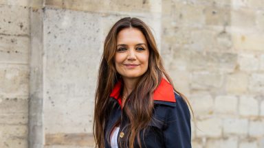 Katie Holmes in a navy red jacket during Paris Fashion Week