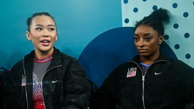 US' Sunisa Lee and US' Simone Biles sit during the artistic gymnastics women's all around final during the Paris 2024 Olympic Games