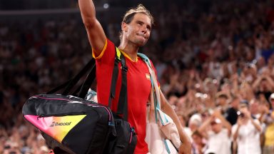 PARIS, FRANCE - JULY 31: Rafael Nadal of Team Spain acknowledges the crowd as he leaves the court with partner (out of frame) Carlos Alcaraz of Team Spain after their Men's Doubles Quarter-final match against Austin Krajicek of Team United States and Rajeev Ram of Team United States on day five of the Olympic Games Paris 2024 at Roland Garros on July 31, 2024 in Paris, France. (Photo by Julian Finney/Getty Images)