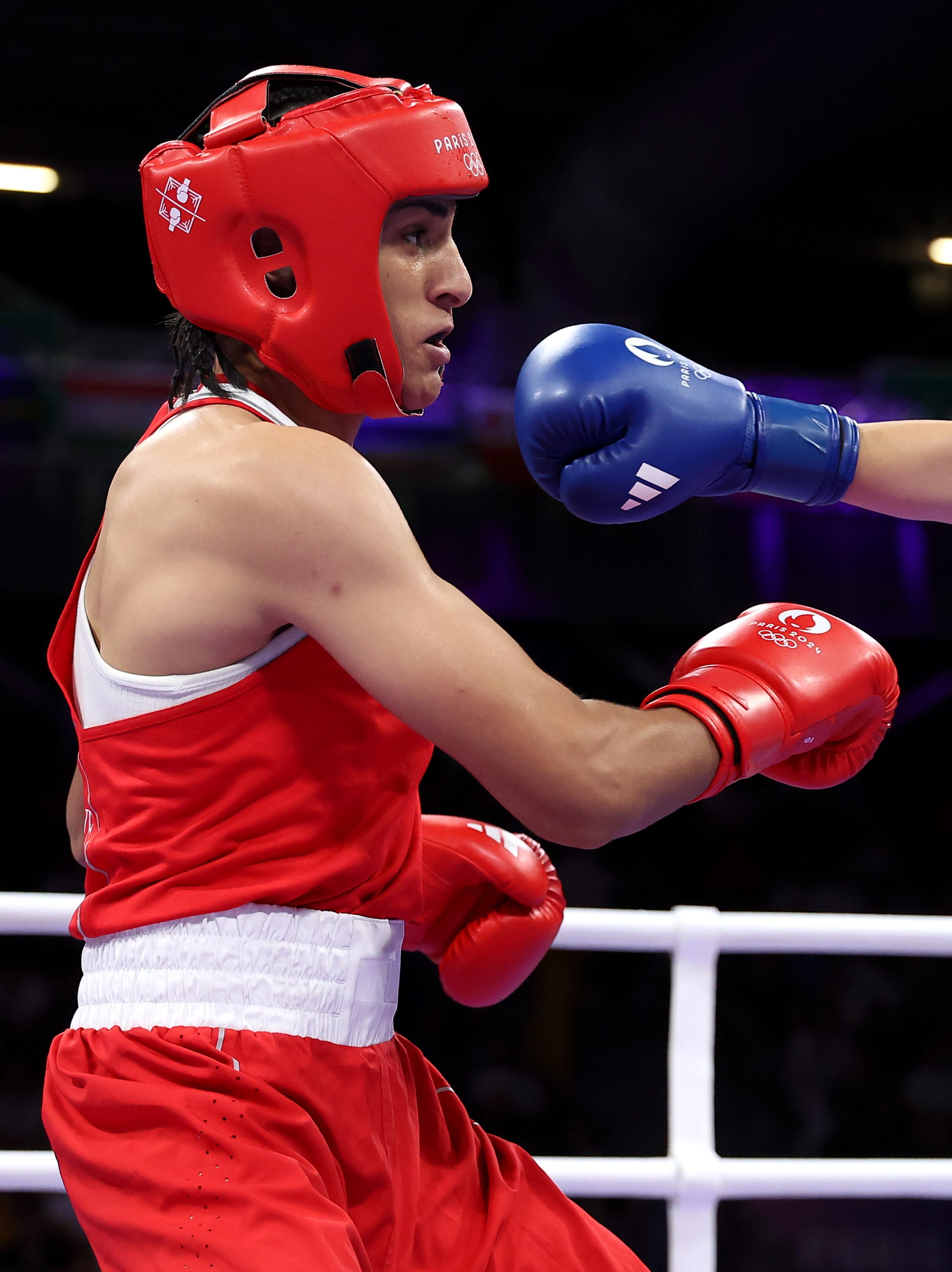 PARIS, FRANCE - AUGUST 01: Imane Khelif of Team Algeria dodges a punch from  Angela Carini of Team Italy during the Women's. 66kg preliminary round match on day six of the Olympic Games Paris 2024 at North Paris Arena on August 01, 2024 in Paris, France. (Photo by Richard Pelham/Getty Images)
