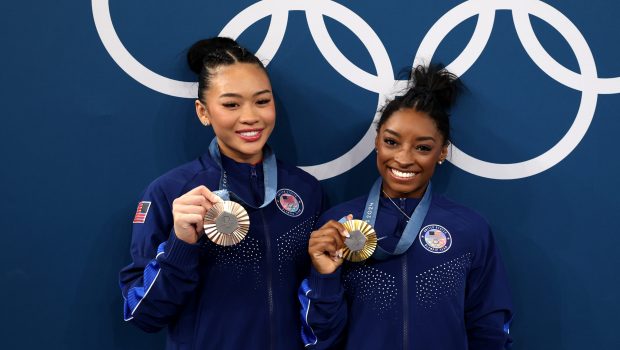 PARIS, FRANCE - AUGUST 01: (L-R) Bronze medalist Sunisa Lee and Gold medalist Simone Biles of Team United States pose with the Olympic Rings during the Artistic Gymnastics Women's All-Around Final medal ceremony on day six of the Olympic Games Paris 2024 at Bercy Arena on August 01, 2024 in Paris, France. (Photo by Jamie Squire/Getty Images)