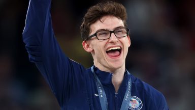 PARIS, FRANCE - AUGUST 03: Bronze medalist Stephen Nedoroscik of Team United States celebrates on the podium during the medal ceremony for the Artistic Gymnastics Men's Pommel Horse Final on day eight of the Olympic Games Paris 2024 at Bercy Arena on August 03, 2024 in Paris, France. (Photo by Julian Finney/Getty Images)