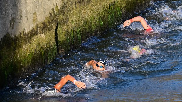 PARIS, FRANCE - AUGUST 08: Athletes compete in the Marathon Swimming Women's 10k on day thirteen of the Olympic Games Paris 2024 at Pont Alexandre III on August 08, 2024 in Paris, France. (Photo by Mehmet Murat Onel/Anadolu via Getty Images)