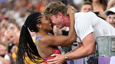 Gold medallist US' Tara Davis-Woodhall (L) celebrates with her husband US' track and field paralympic athlete Hunter Woodhall (R) after winning the women's long jump final of the athletics event at the Paris 2024 Olympic Games at Stade de France in Saint-Denis, north of Paris, on August 8, 2024. (Photo by Kirill KUDRYAVTSEV / AFP) (Photo by KIRILL KUDRYAVTSEV/AFP via Getty Images)