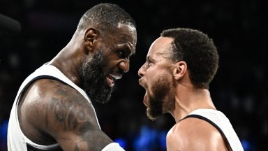 TOPSHOT - USA's #06 LeBron James (L) celebrates with USA's #04 Stephen Curry at the end of the men's semifinal basketball match between USA and Serbia during the Paris 2024 Olympic Games at the Bercy  Arena in Paris on August 8, 2024. (Photo by Aris MESSINIS / AFP) (Photo by ARIS MESSINIS/AFP via Getty Images)